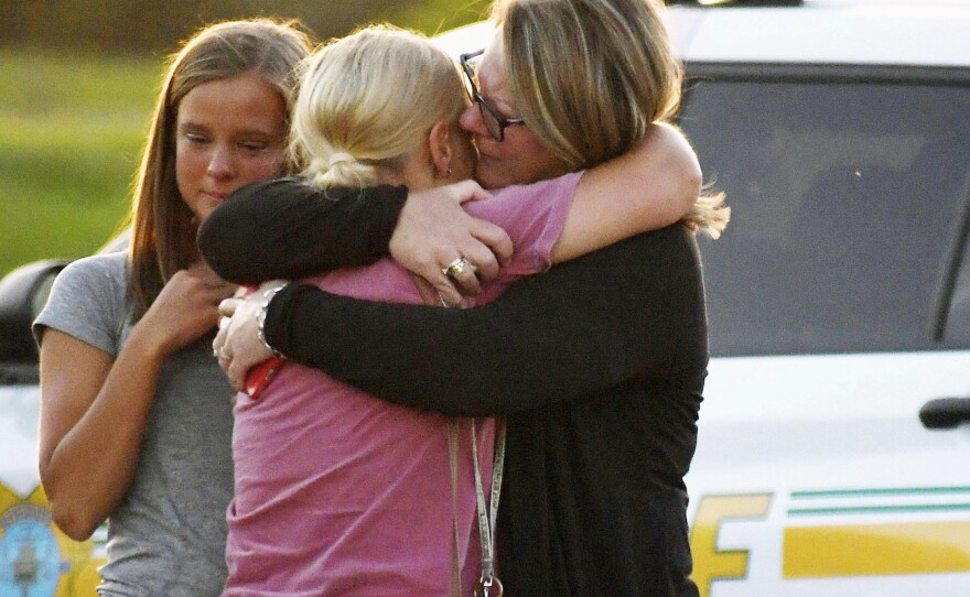 People console each other after a shooting at Cornerstone Church on Thursday, June 2, 2022 in Ames, Iowa.