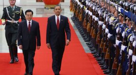 U.S. President Barack Obama (R) inspects a guard of honor along with Chinese President Hu Jintao (L) at the Great Hall of the People on November 17, 2009 in Beijing, China. 