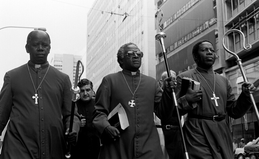 South African activist and Anglican Archbishop Desmond Tutu (center) leads some 30 clergymen through Johannesburg to police headquarters in 1985 to hand in a petition calling for the release of political detainees.