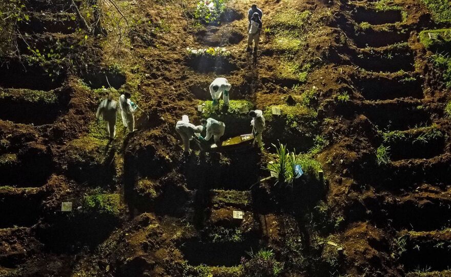 An aerial view showing a coffin being buried at the Vila Formosa cemetery in Sao Paulo, Brazil, late last month. Brazil has been experiencing record numbers of coronavirus infections and COVID-19 deaths in recent weeks.