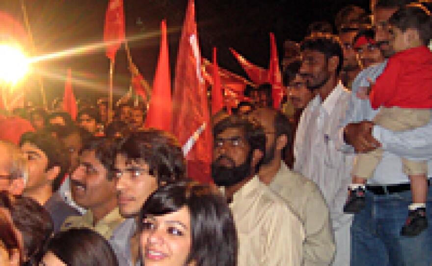 Fans listen to Laal perform in the parking lot of a Lahore newspaper building.