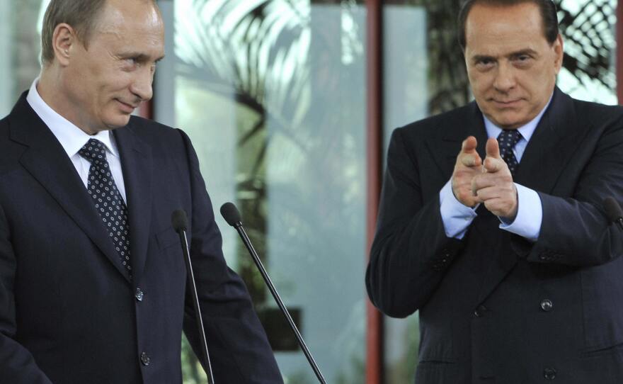 Silvio Berlusconi pretends to shoot at a journalist during a press conference with Russian President Vladimir Putin in April 2008. The journalist had asked Putin about rumors of his relationship with Alina Kabaeva.