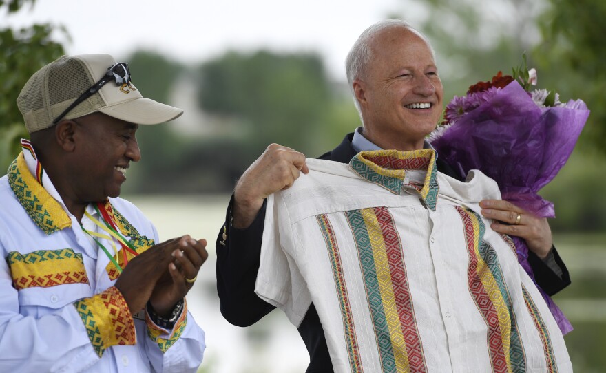U.S. Rep. Mike Coffman, R-Colo., accepts a gift of a traditional Ethiopian shirt from Girum Alemayehu at an Ethiopian festival in Denver in August 2016. Coffman has survived multiple tough re-election campaigns in part due to his outreach to various immigrant communities in his district.