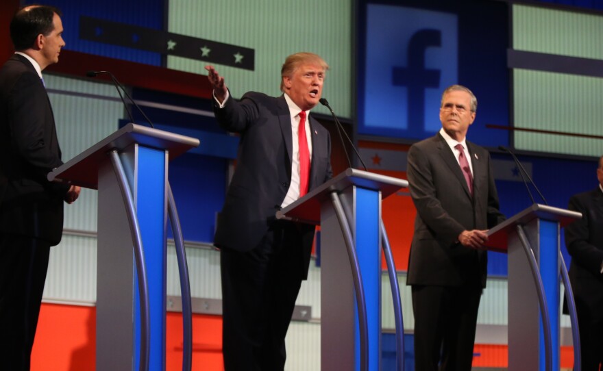 Republican presidential candidates (from left) Scott Walker, Donald Trump, Jeb Bush and Mike Huckabee take the stage for the first Republican presidential debate.