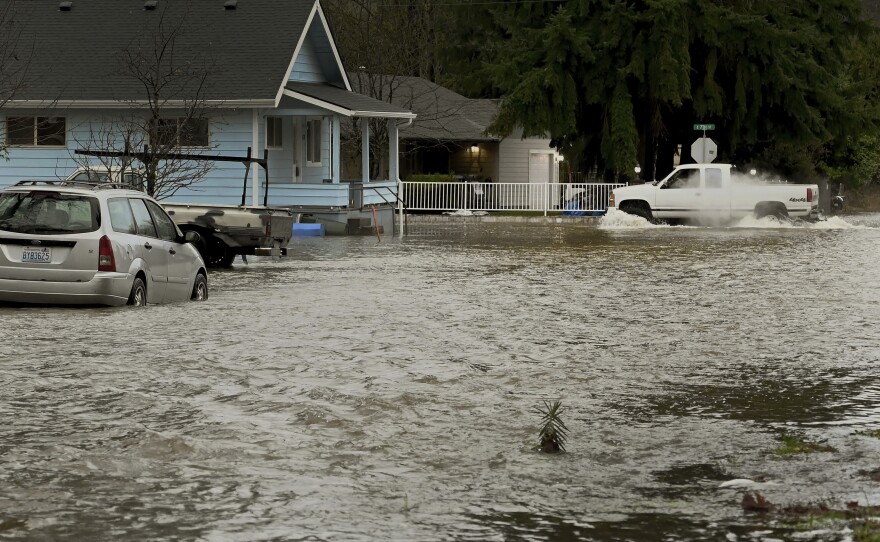 Rising water from the nearby Skookumchuck River begins to inundate several streets in the town of Bucoda, Wash., Friday, as area rivers and snow runoff begin to accelerate flooding in the south sound.