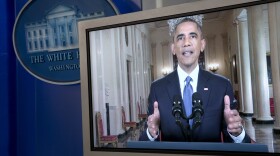 President Barack Obama is seen on a monitor in the briefing room of the White House as he speaks to the nation about his executive action that will affect millions of immigrants living illegally in the U.S., Nov. 20, 2014. 