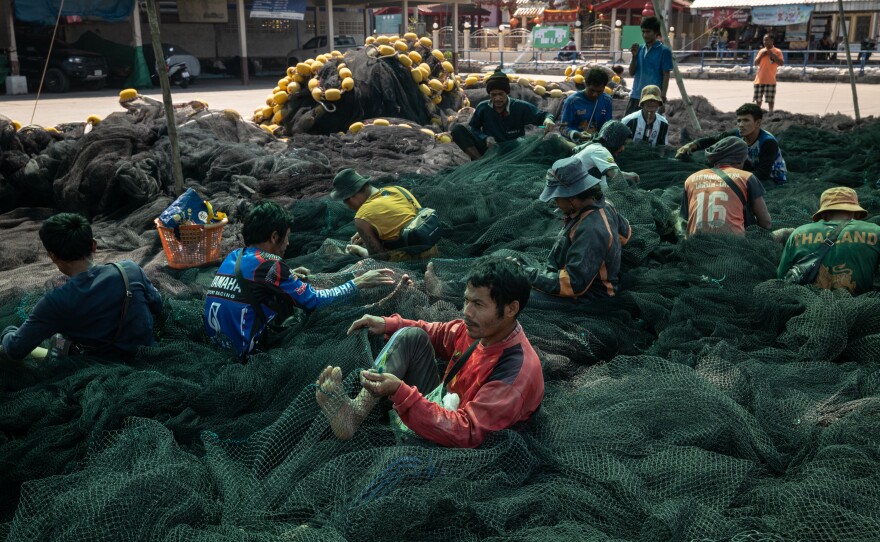 Fishermen mend nets in Samut Sakhon, Thailand, on Jan. 15, 2025.