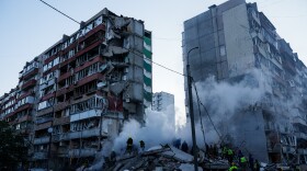 Rescue workers clear the rubble of a house heavily damaged after a Russian strike on a residential neighborhood in Kyiv, Ukraine, on Thursday, May 14, 2026.