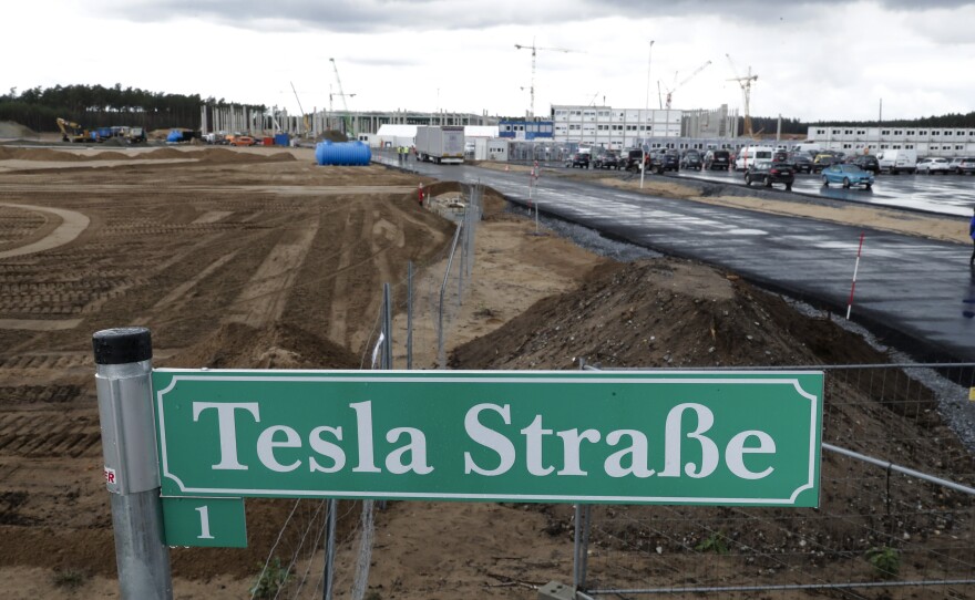 A street sign says "Tesla Street 1" in front of the construction site of the Tesla Gigafactory near Berlin. The electric automaker plans to start building cars this summer at its first European production site.