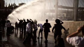 Police use water cannon to disperse ultra-Orthodox Jewish men blocking a street during a protest against the country's military draft in Jerusalem, April 29.