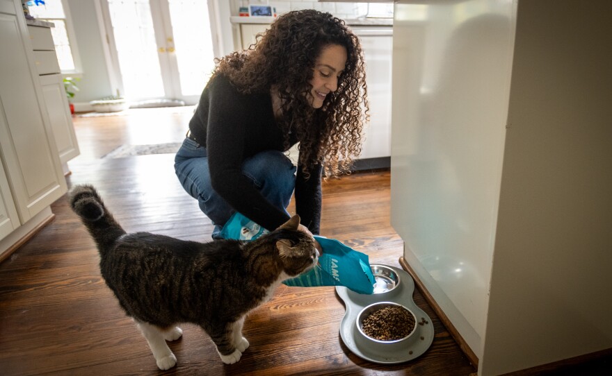 Karen Seagraves feeds her cat, Little Buddy, in her home in Charlotte, N.C.