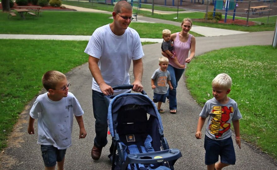 Sgt. Nathan Scheller was twice denied for a Purple Heart, though roadside bomb explosions left him with lasting cognitive damage. Above, Scheller walks with his wife, Miriam, and his family.