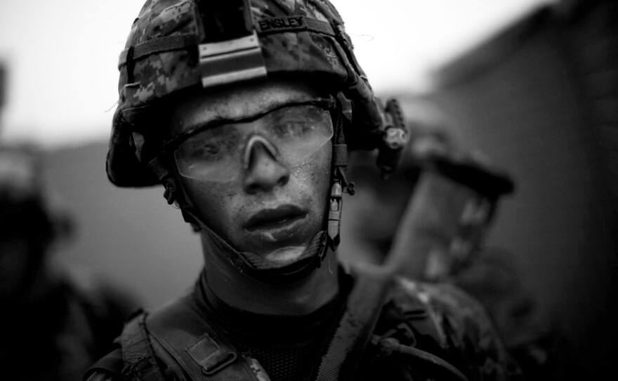 Pvt. Cody Lee Ensley, with Bravo Company, 101st Airborne Division, walks through the safety of the gates at Forward Operating Base JFM after a daylong fierce attack by insurgents near the village of Payendi, in the Pashmul District of Kandahar province.