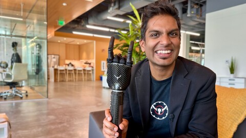 Adheel Akhtar, CEO and founder of PSYONIC, poses with a demo version of the company's bionic prosthetic hand in the KPBS newsroom in San Diego, July 22, 2024.