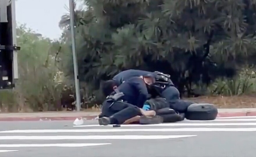 Still from a cell phone video showing a San Diego Police officer rough arrest of a homeless man in La Jolla, May 12, 2021.