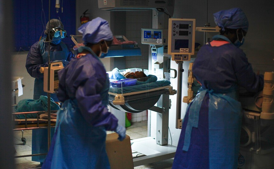 Three nurses tend to a newborn in JFK Memorial Hospital's neonatal intensive-care unit on Oct. 13. Since reopening in August, the hospital has delivered 500 babies and treated about 1,500 patients.