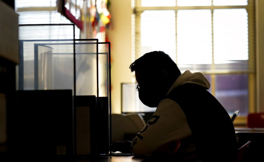 Senior Jose Solano-Hernandez takes a test on the first day of in-person learning at Wyandotte High School in Kansas City, Kan., Wednesday, March 30, 2021.