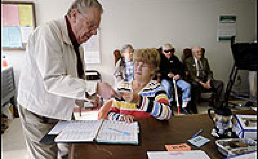 A campaign official helps a Pennsylvania voter on Tuesday in Butler, Pa.