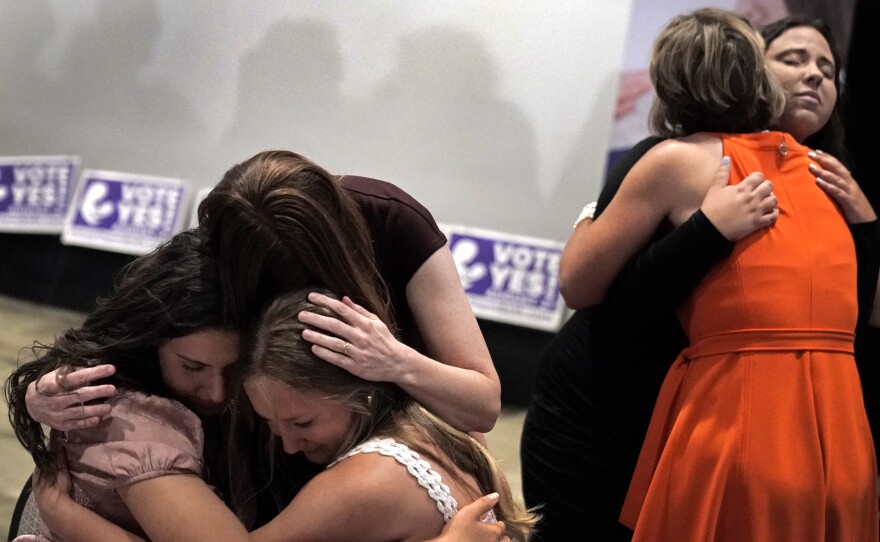 File photo of people hugging during a "Value Them Both" watch party after a question involving a constitutional amendment removing abortion protections from the Kansas constitution failed, Aug. 2, 2022, in Overland Park, Kan.