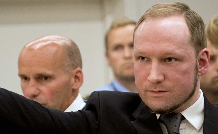 Anders Breivik raises his fist in a right-wing salute after being sentenced to 21 years in prison at the Oslo District Court on Aug. 24, 2012.