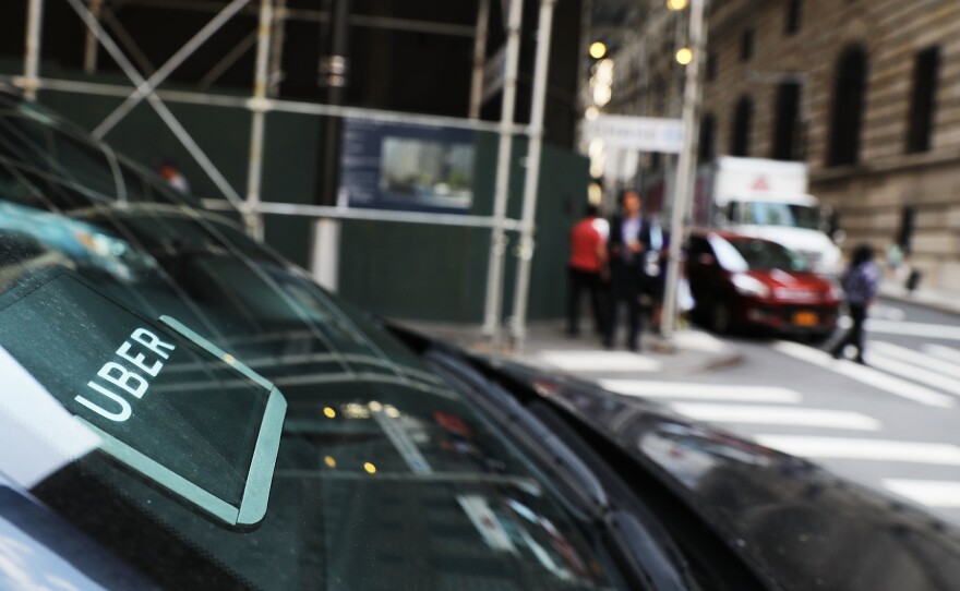 An Uber car waits for a client in Manhattan last June. Uber says customers, drivers and employees who are sexually harassed or assaulted won't have to go to arbitration, which required them to keep their stories private.