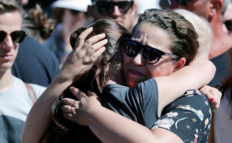 Women react near the scene of Thursday evening's attack in Nice.