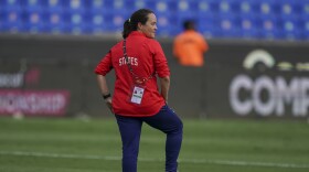 Twila Kilgore, assistant coach on the U.S. team watches players warm up prior to a CONCACAF Women's Championship soccer semifinal match against Costa Rica in Monterrey, Mexico, Thursday, July 14, 2022.