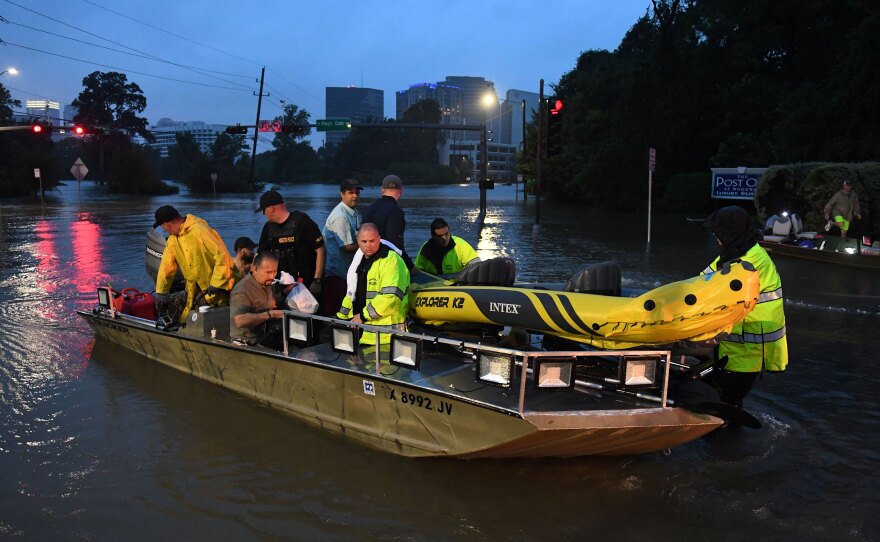 People are rescued from a hotel by boat after Hurricane Harvey caused heavy flooding in Houston on Sunday.