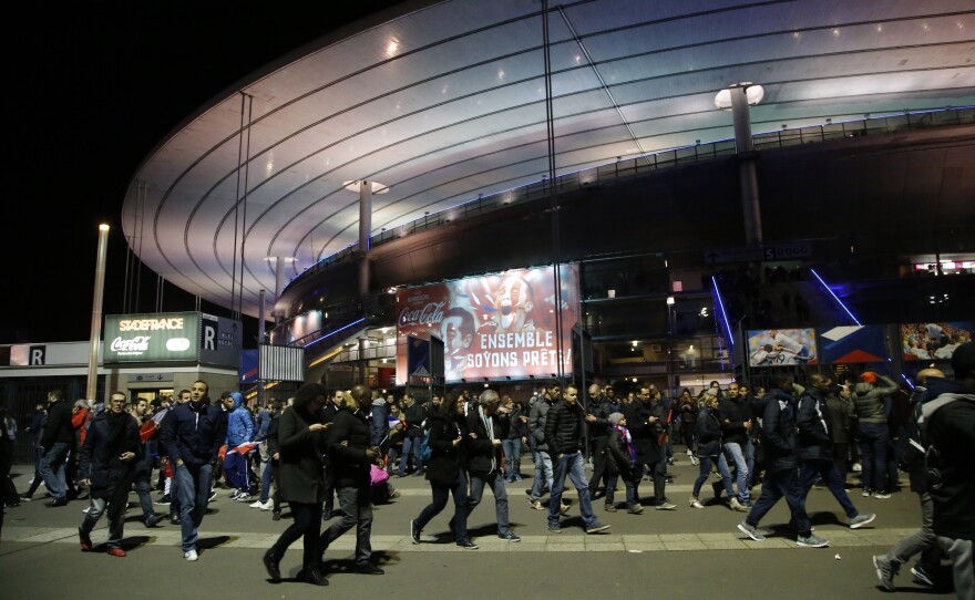 People leave the Stade de France stadium after the international friendly soccer France against Germany, Nov. 13, 2015 in Saint Denis, outside Paris.