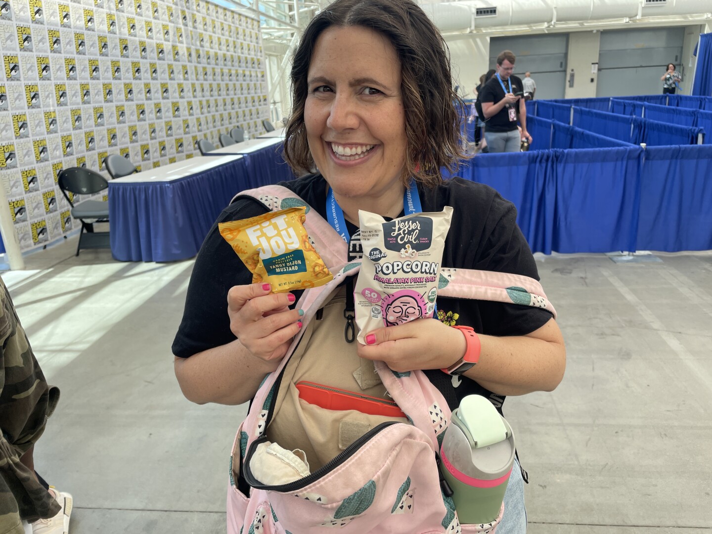 San Diego writer Lauren Marie Fleming poses with her Comic-Con survival supplies on Thursday, July 24, 2025. "I'm gluten free, so I have to bring snacks," she said.