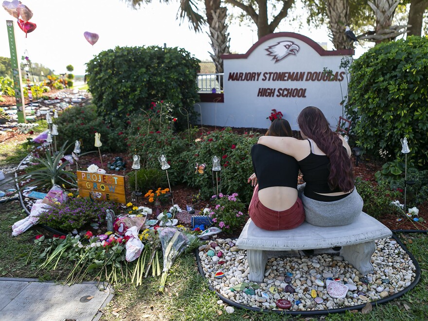 Mourners visit a memorial outside of Marjory Stoneman Douglas High School in Parkland, Fla., in 2020, on the two-year anniversary of the Parkland shootings.