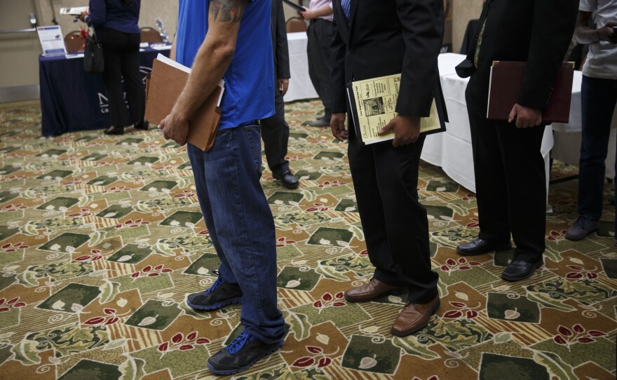 Job seekers wait to speak with representatives during a Choice Career Fair this summer in Los Angeles.