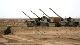 Libyan soldiers loyal to Moammar Gadhafi man artillery cannons at the western entrance of the city of Ajdabiya on Wednesday.