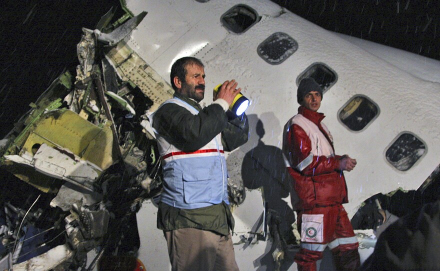 Rescue workers look through the wreckage of an Iran Air Boeing 727 plane that crashed in northwest Iran as it was making an emergency landing in 2011. More than 70 of the 106 on board were killed. Iran's aging airline fleet has had a poor safety record.