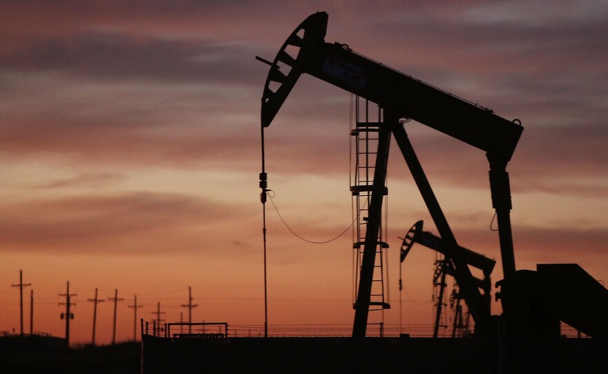 An oil pumpjack works at dawn Jan. 20 in the oil town of Andrews, Texas.