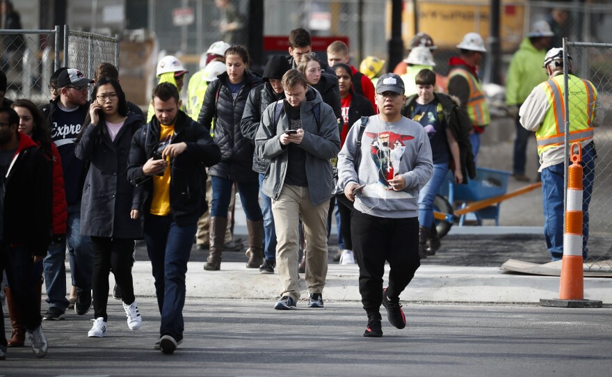 Students leave buildings as police respond to an attack Monday on campus at Ohio State University in Columbus, Ohio.