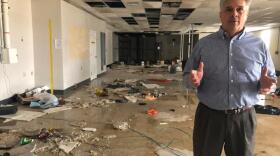 Tony Sholar of the Marine Corps stands in the abandoned headquarters of a Marine unit at Camp Lejeune, N.C., in this undated photo. The building was damaged in Hurricane Florence, and rainwater still pours through damaged roof.