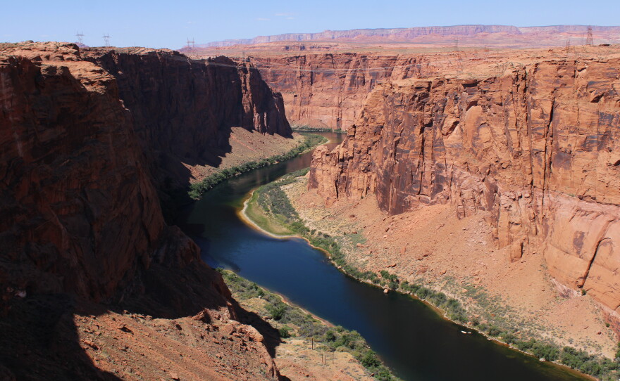 The Colorado River flows near Page, Arizona on May 14, 2026. The river can no longer provide enough water to meet current demands, but the seven states that use it have not been able to agree on a plan to reduce their take. A federal plan to cut back on water demand has proven unpopular, triggering legal action from some of the states facing cutbacks.