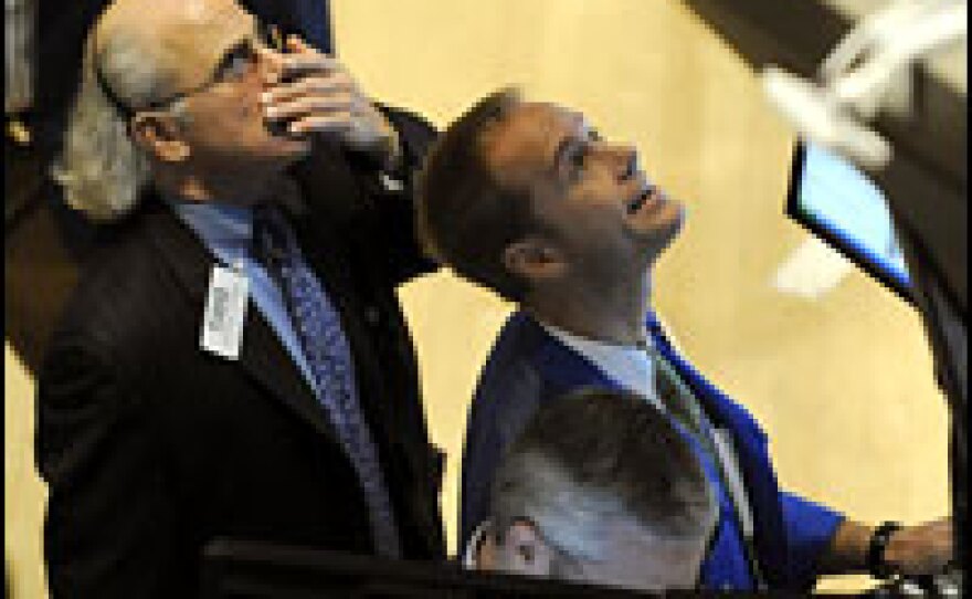 Traders on the floor of the New York Stock Exchange look up at the opening numbers on Wednesday.