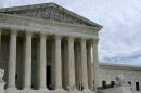 People walk outside the U.S. Supreme Court in Washington, D.C., on Friday.