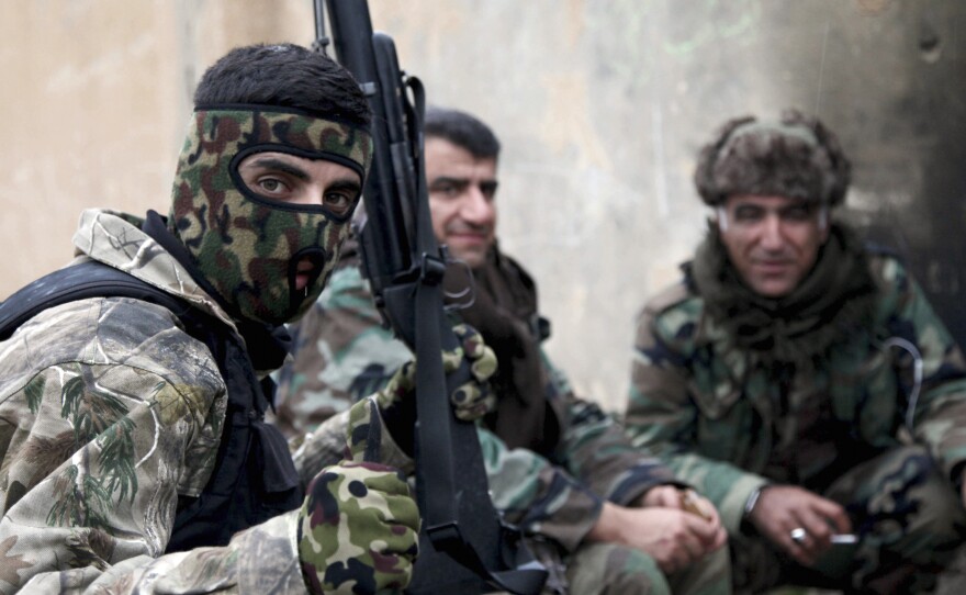 Kurdish peshmerga fighters rest on the outskirts of Mosul on Jan. 30.