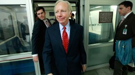 Sen. Joe Lieberman walks off the Capitol subway Tuesday, after discussing his opposition to expanding Medicare in the Senate's health care reform bill.