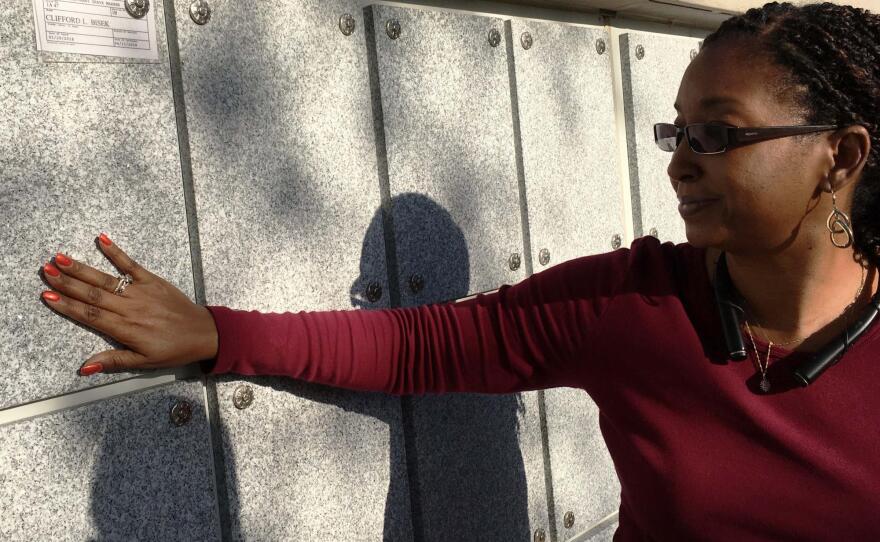 Bay Pines Cemetery Director Eugenia Simmons bids farewell to veteran Cliff Bisek, one of 10 unattended interments at Bay Pines in April, 2018.