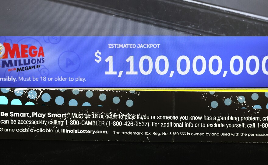 Lottery jackpots are soaring past the billion-dollar mark more frequently, thanks to higher interest rates and several rules changes. Here, a ticket machine displays the projected jackpot for a Mega Millions drawing in Chicago, in early January.