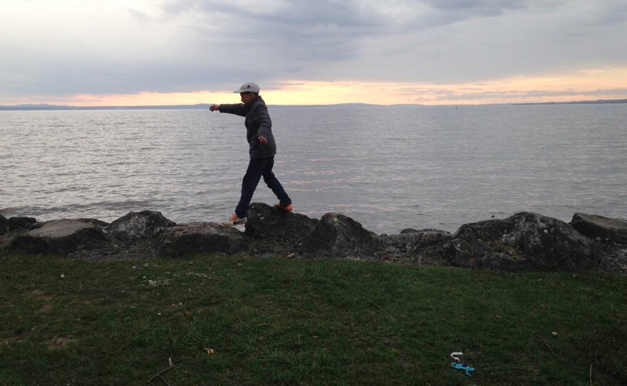 Hamudeh al-Masaadi plays on the shores of Lake Constance near Friedrichshafen, where they wait as their request for asylum is processed.