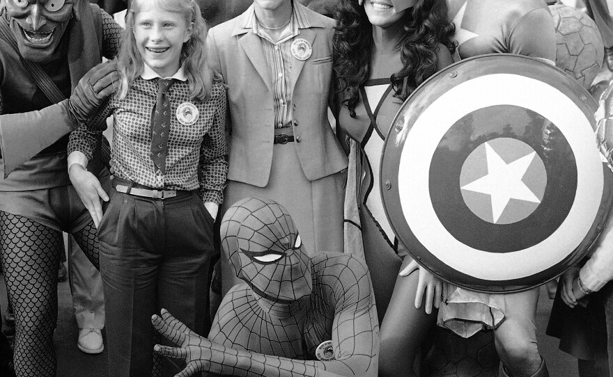 First lady Rosalynn Carter and daughter Amy are surrounded by comic book characters gathered at the White House in October 1980 to support President Jimmy Carter's program for energy efficiency.