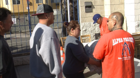 People line up at the Neil Good Day Center in downtown San Diego to get blankets and sheets of plastic to keep them warm and dry ahead of a cold snap forecast to hit the region, December 5, 2013.