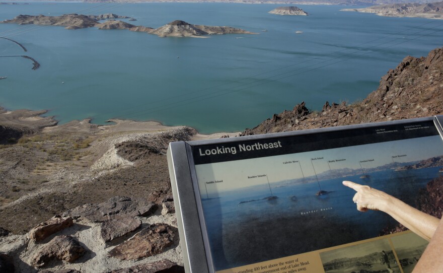 Dropping water levels reveal larger islands in Lake Mead compared to a picture on an interpretive sign overlooking the lake in the Lake Mead National Recreation Area in Nevada. A 14-year drought has caused the water level in the reservoir to shrink to its lowest point since it was first filled in the 1930s.