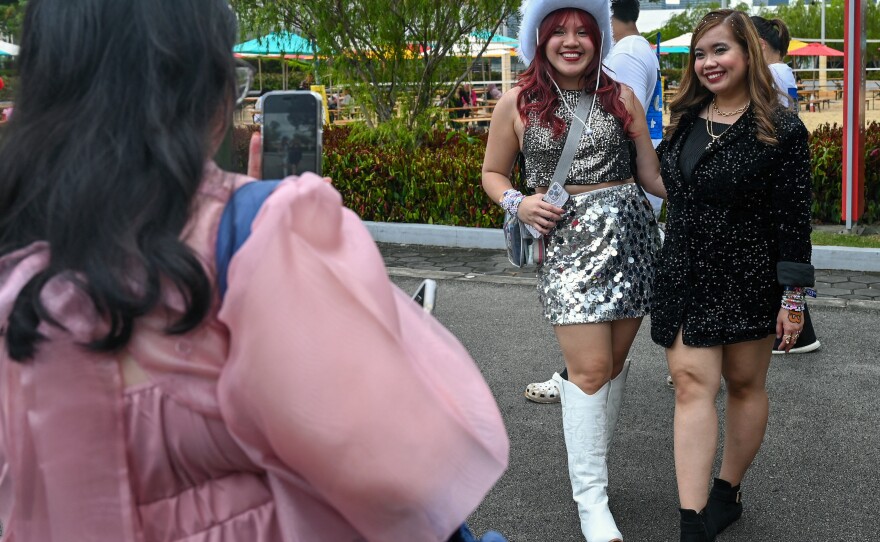 Taylor Swift fans, known as a Swifties, take photos as they arrive for the first of the pop star's six sold-out Eras Tour concerts at the National Stadium in Singapore on March 2.