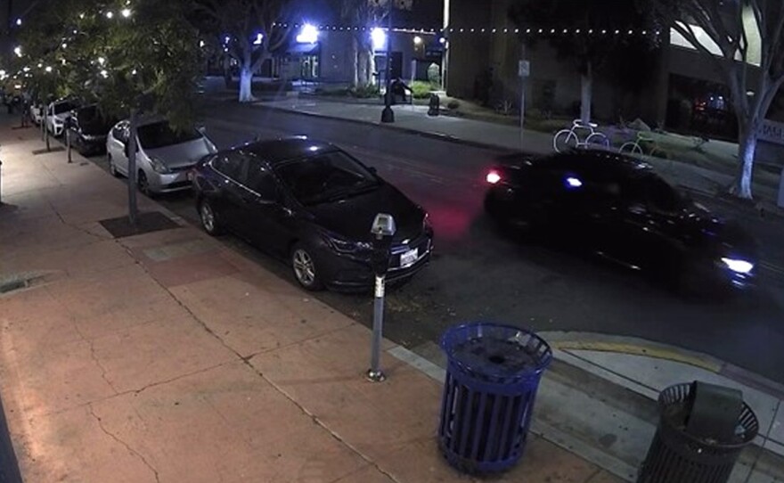 A screenshot from surveillance video outside The Rail bar in Hillcrest shows a dark-colored sedan (upper right) that was also seen at other nearby bars attacked by drive-by pellet shootings, San Diego, Calif., May 18, 2024